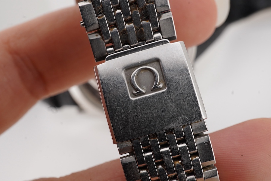 A gentleman's 1980's stainless steel Omega Seamaster quartz wrist watch, with baton numerals and date aperture, case diameter 33mm, (glass cracked), on a stainless steel Omega bracelet, no box or papers, together with on